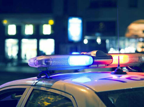 Police car with flashing lights at night.