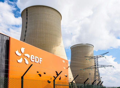cooling towers at a power plant behind security fence